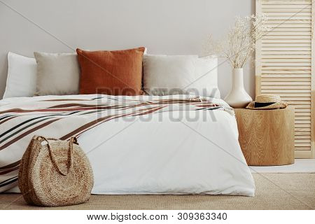 Natural Bright Bedroom Interior With Wooden And Wicker Accents