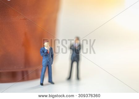 Business Planning Concept.  Close Up Of Two Businessman Minaiture Figure Standing And Thinking  With