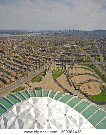 Aerial view of Montreal Olympic Park and downtown skyline in Montreal, Quebec, Canada. Montreal Olympic Park is the site of the 1976 Summer Olympic Games.