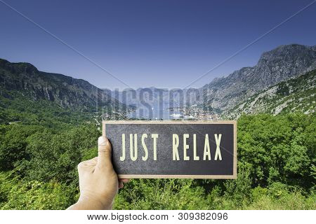 Just Sit Back Relax And Enjoy Life Sign On Board Mock Up Copy Space Overwrite View On Summer Bay Sea