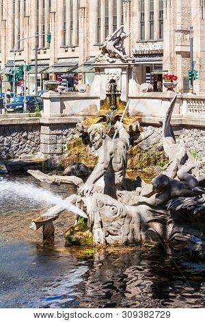 Dusseldorf, Germany - July 02, 2018: Triton Fountain Or Tritonenbrunnen Located At Konigsallee Or Ki