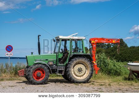 Bogo Denmark - June 30. 2018: Old Fendt Tractor With A Crane