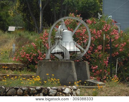 Garden In Drytown With Bushes And Bell
