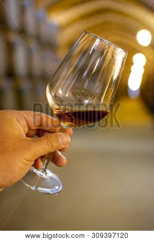 Tasting Of Fortified Dry Or Sweet Marsala Wine In Vintage Wine Cellar With Old Oak Barrels In Marsal