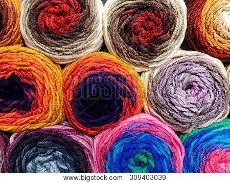 Texture Of Different Colored Balls Of Wool. Woolen Threads Of Different Colors. Conceptual For Hobbi