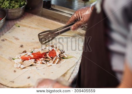 Cooking Fajitos In The Cafe. Cooking Shawarma In Pita In The Kitchen. Wrap Chicken, Carrots, Lettuce