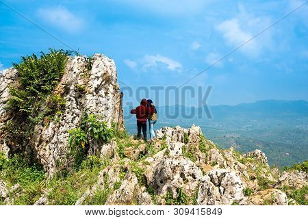 Couple Of Rock Climber Celebrating And Enjoying Their Achievement At The Top Of Mountain With The Sc