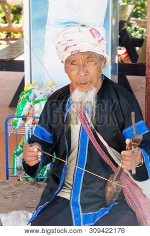 Chiang Rai, Thailand - December 10th 2014: Lahu Hilltribe Man Playing A String Instrument. There Are