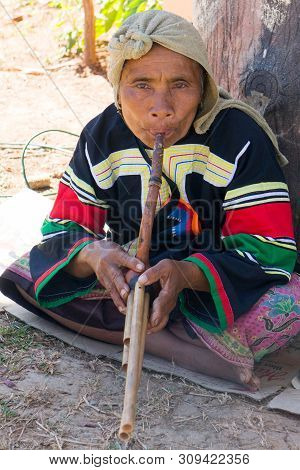 Chiang Rai, Thailand - December 10th 2014: Lahu Hilltribe Woman Playing A Wind Instrument. There Are