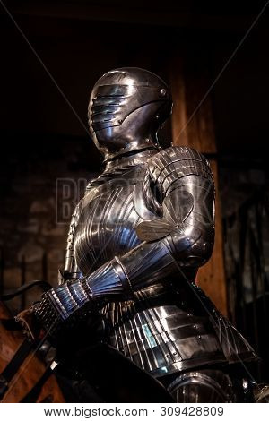 Medieval Like Shiny Armour Suit And Helmet In Position Of Riding A Horse
