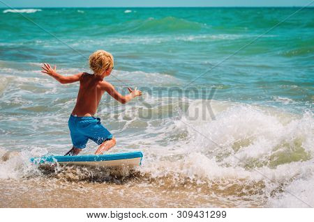 Happy Boy Enjoy Surfing At Sea, Kids Play With Water On Vacaton
