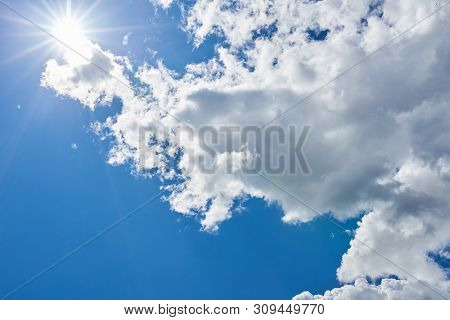 Blue Sky With Beautiful, Gray-white, Clouds And Brightly Shining Sun For Any Purpose