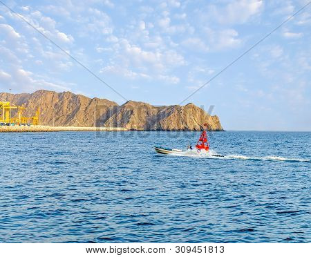 Speed Fishing Boat Moving Right Next To A Red Buoy Near Muttrah Port, Muscat, Oman.