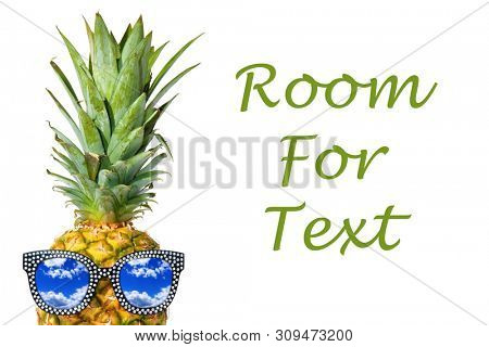 Pineapple. Pineapple Peak. A Sunglasses wearing Pineapple peaks from a white background. Pineapple with sunglasses. Isolated on white. Room for text. clipping path. 