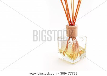 Home Perfume In A Glass Bottle With Wooden Sticks, Isolated On White Background. Elegant Spa Decorat