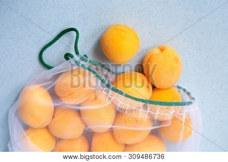 Apricots In Eco-friendly Packaging. Reusable Bags For Vegetables And Fruits. Shopping In The Store, 