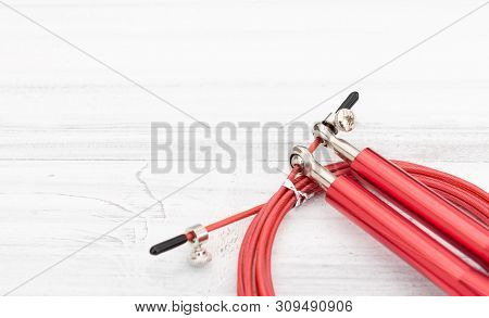 Modern Red Jump Rope On White Wooden Background,flat Lay