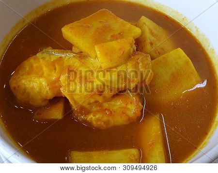 Thai Food Style,top View Sour Soup With Snapper And Young Coconut Shoots In White Bowl As A Backgrou