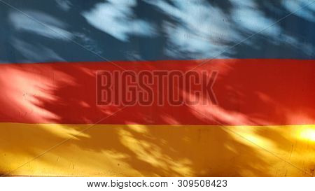 Striped Abstract Background Of Three Vibrant Colors And Blurry Shadows With Sunlight Spots On Them. 