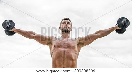Always In Shape. Muscular Man Exercising In Morning With Barbell. Success. Perfect Biceps. Athletic 