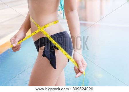 Woman In Sexy Bikini With Slim Body Measuring Thigh With Measurement Type After Diet With Swimming P