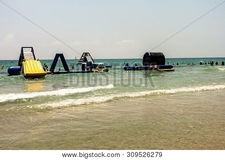 Mil Palmeras, Costa Blanca, Spain - July 02 2019: People On Beach Enjoying The Sun And Playing On In