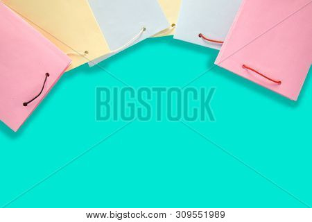 Colorfull Empty Paper Shopping Bag On Blue Color Background