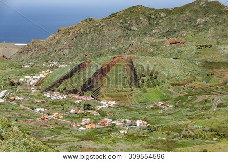 Valley Of El Palmar In The Teno Mountains With Green Slopes. In The Center - Volcanic Hill Like A Sl