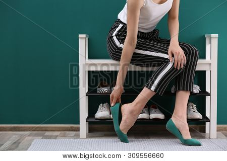 Woman Putting On Shoes Indoors, Closeup With Space For Text. Stylish Hallway Interior