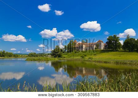 Beautiful Landscape With Ancient Svirzh ( Svirz ) Castle On The Hill Against The Blue Sky And White 