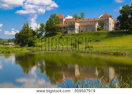 Beautiful Scene With Ancient Svirzh ( Svirz ) Castle On The Hill Against The Blue Sky And White Clou