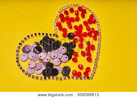 Embroidery Products And Tools. Heart, Rhinestone, Sequin And Red Roundels On A Yellow Background.