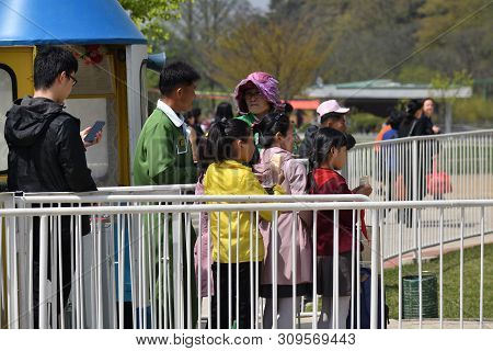 Pyongyang, North Korea - May 1, 2019: Children Expect To Use Rides And Eat Ice Creams In The Taesong
