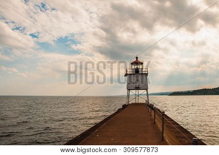 Close Up Of Navigation Light Ontwo Harbors Breakwall In Agate Bay Of Lake Superior With Sunlight Shi