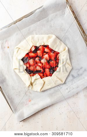 Homemade Strawberry Open Cake Of Gallet With Purple Basil And Balsamic Sauce Before Baking On A Ligh