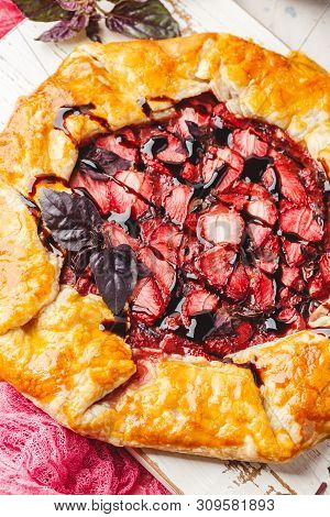 Homemade Strawberry Open Pie Gallet With Purple Basil And Balsamic Dressing On A Light Background. C