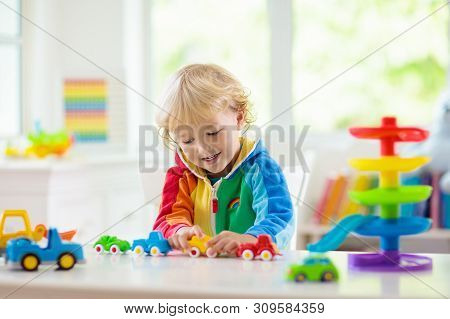 Boy Playing Toy Cars. Kid With Toys. Child And Car