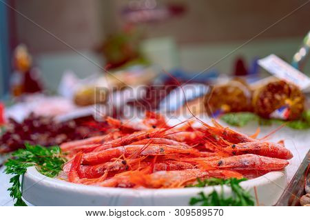 Frozen Red Prawns On The Spanish Fish Market.  Selective Focus. Bokeh. Food Market In Barcelona