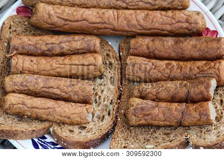 Frikandel On A Slice Of Bread, A Traditional Dutch Snack, A Sort Of Minced Meat Hot Dog