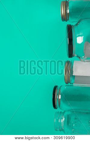 Isolated Glass Jars, Flat On Teal Mint Green Background Room, Copy Space On Left