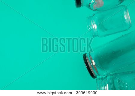 Isolated Glass Jars, Flat On Teal Mint Green Background Room, Copy Space On Left