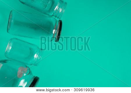 Isolated Glass Jars, Flat On Teal Mint Green Background, Room Copy Space Right