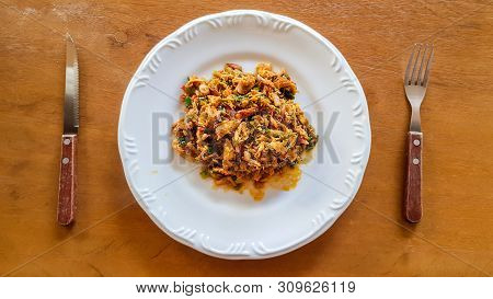 Catado De Siri: Brazilian Food Made Of Crab Meat In A White Plate With A Fork And Knife On A Wooden 