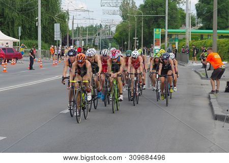 Dnipro, Ukraine - June 08, 2019: Group Of Female Athletes On A Bicycle Section On A City Street Duri