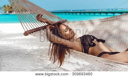 Woman Relaxing In The Hammock On Tropical Beach, Summer Vaction. Free Girl Chilling On Exotic Island