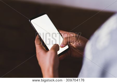 Man Hand Holding Mobile Phone In Coffee Shop. Man Using Smartphone. Empty Screen With Copy Space For
