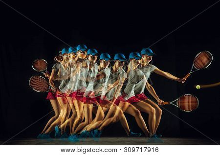 One Caucasian Woman Playing Tennis Isolated On Black Background In Mixed And Stobe Light. Fit Young 