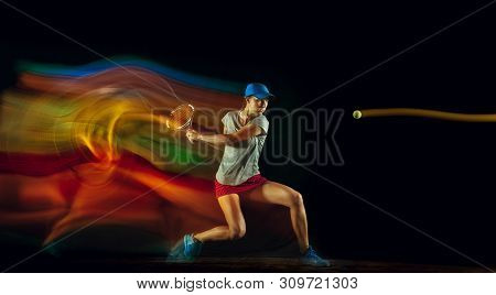 One Caucasian Woman Playing Tennis Isolated On Black Background In Mixed And Stobe Light. Fit Young 