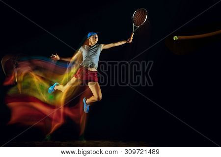 One Caucasian Woman Playing Tennis Isolated On Black Background In Mixed And Stobe Light. Fit Young 