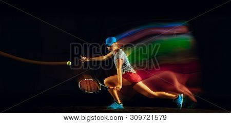 One Caucasian Woman Playing Tennis Isolated On Black Background In Mixed And Stobe Light. Fit Young 